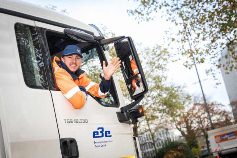 Fahrer winkt aus dem LKW-Fenster